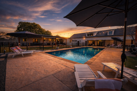 Austin resort-style vacation rental with outdoor dining for 12 under string lights, private backyard, and luxury group accommodations near downtown Austin