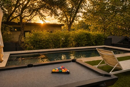 Austin airbnb with pool and downtown views. Enjoy outdoor pool table, loungers with umbrellas